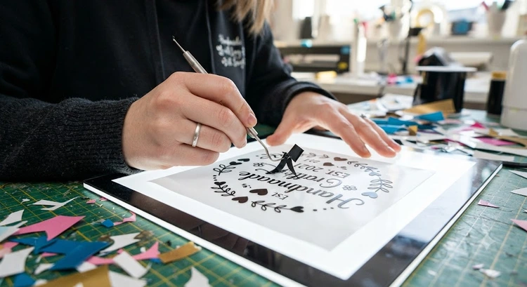 how to weed heat transfer vinyl using a hook tool on a light box